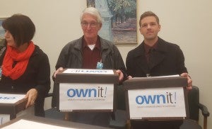 CUPE Saskatchewan President Tom Graham and Executive Assistant Andrew Loewen deliver Own It! petitions to the Legislature. 